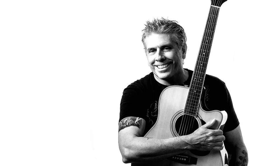 Tim McGeary performing live with his acoustic guitar